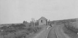 Mdantsane, 1895. Small station building with railwayman sitting on platform. (EH Short)