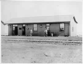 Opening Pretoria - Pietersburg railway. People posing at small station building of corrugated iron.