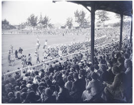 Durban, 1950. Zulu regiment marching past spectators in football arena.