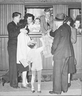 Johannesburg, 1948. Greeting passengers from station platform.