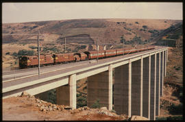 
Passenger train on high concrete bridge.

