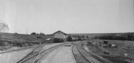 Kubusie, 1895. Train at station building in the distance. (EH Short)