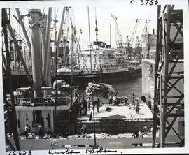 Durban, 1966. Loading bags by crane onto ship in Durban. Harbour.