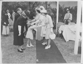 
Shy young girl curtseys as she is  greeted by Princess Margaret.
