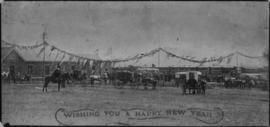 Train and horse carts at railway station with "Wishing you a Happy New Year" imprinted ...