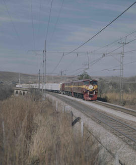 White Train with electrical locomotive on double track.