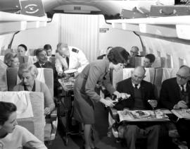
SAA Boeing 707 interior. Cabin service. Steward and hostess.
