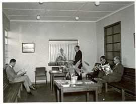 Men reading in waiting room.