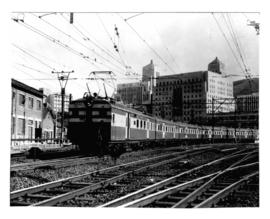 Cape Town, 1961. New electric motor coach train leaving Cape Town railway station on the way to S...