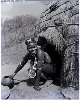 
Zulu woman at hut entrance.
